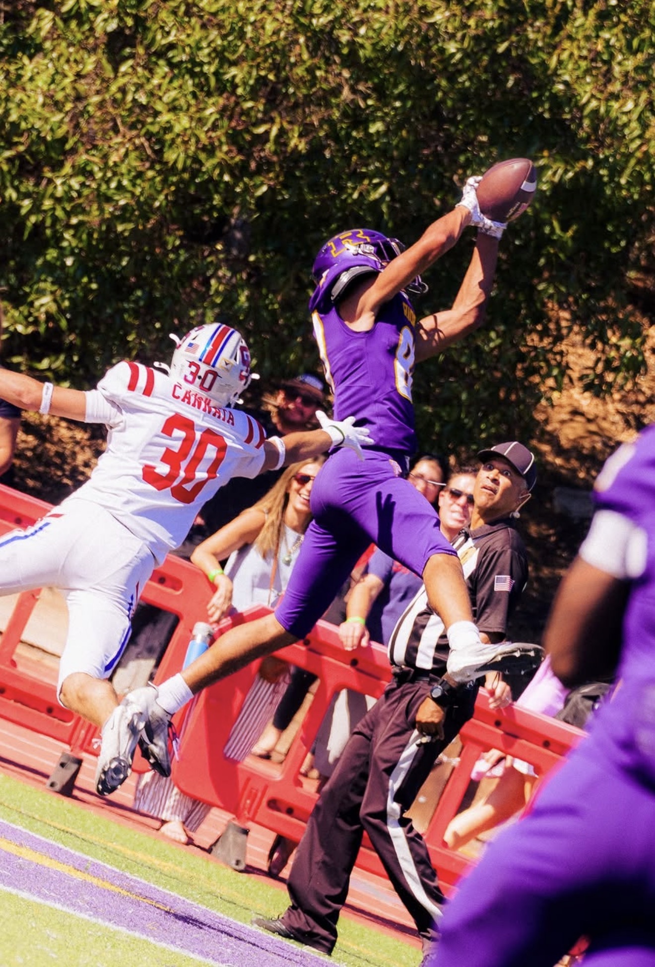 Jeffrey Palega extending for a catch in a football game